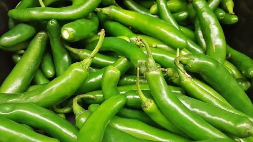chile serrano verde fresco junto a un cuenco de salsa verde